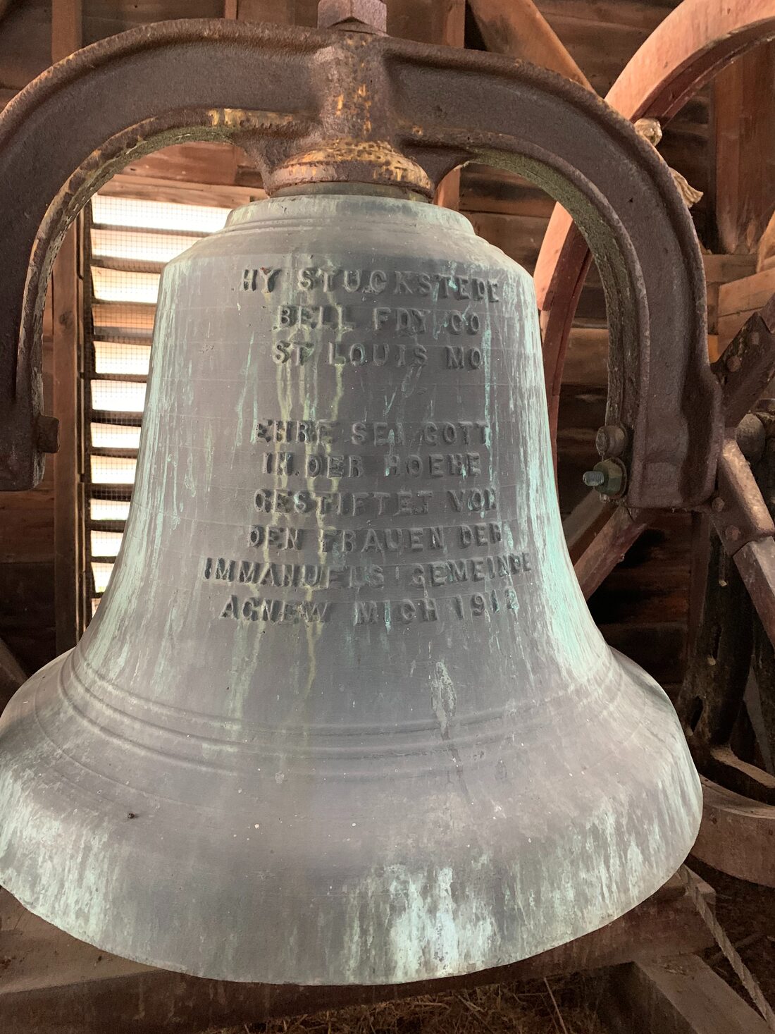 The historic 1912 bronze bell in the steeple of United Lutheran Church, with its German inscription